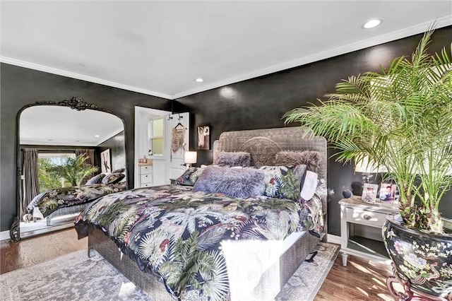 bedroom featuring ornamental molding, arched walkways, baseboards, and wood finished floors