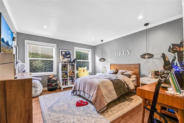 bedroom featuring recessed lighting, crown molding, baseboards, and wood finished floors