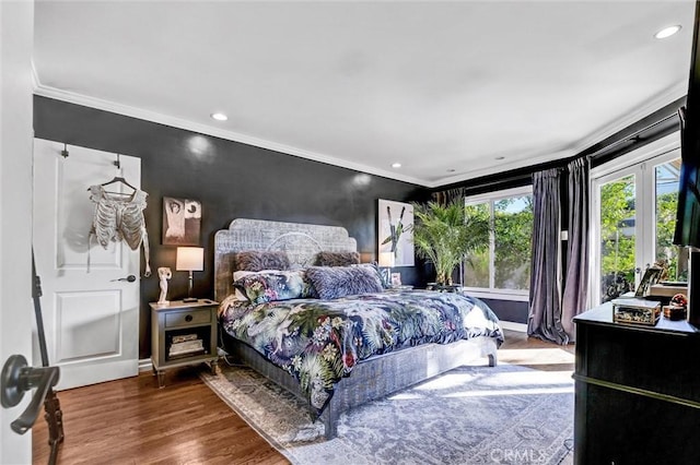 bedroom with ornamental molding, recessed lighting, wood finished floors, and baseboards