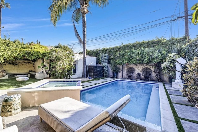 view of pool with an in ground hot tub, a patio, and a fenced backyard