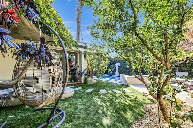 view of yard featuring an outdoor pool and a patio