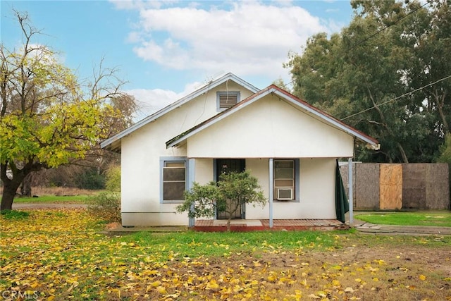 view of side of property featuring a porch and a yard