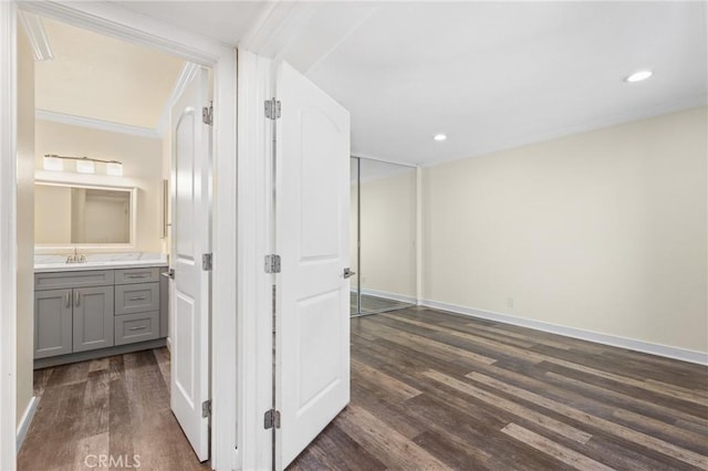 bathroom with crown molding, hardwood / wood-style floors, and vanity