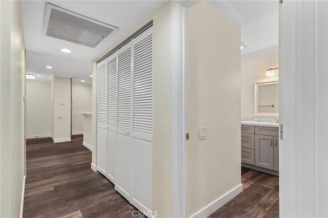 hallway with dark hardwood / wood-style floors and ornamental molding