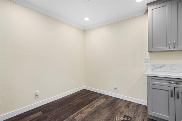 interior space with dark hardwood / wood-style flooring and ornamental molding