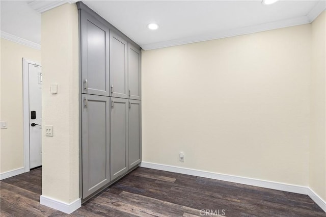 interior space with dark hardwood / wood-style flooring and ornamental molding