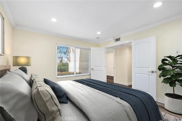 bedroom featuring wood-type flooring and crown molding