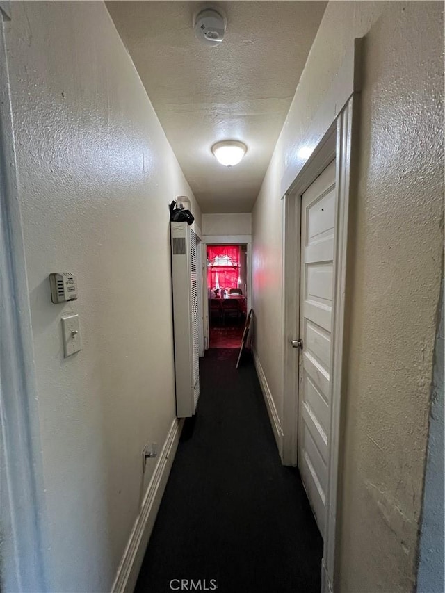 hallway with a textured ceiling