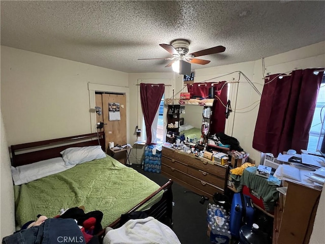 bedroom featuring ceiling fan, a textured ceiling, and a closet