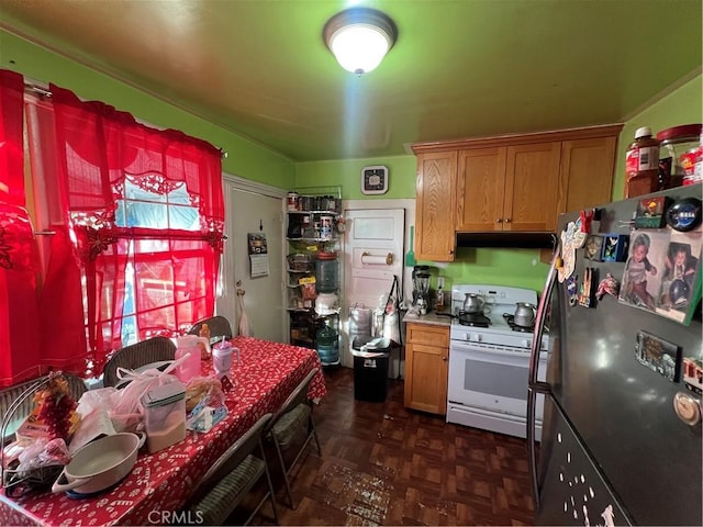 kitchen featuring gas range gas stove, fridge, and dark parquet flooring