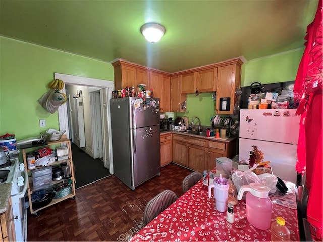 kitchen featuring white refrigerator, sink, dark parquet floors, and stainless steel refrigerator