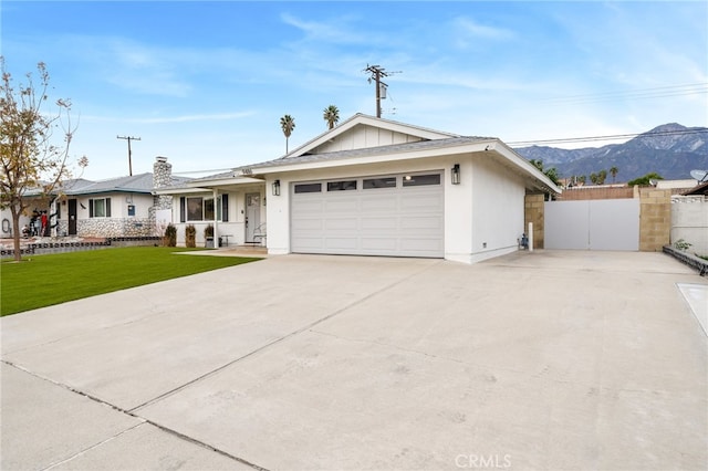 single story home featuring a front yard, a garage, and a mountain view