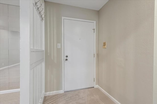 doorway with light colored carpet