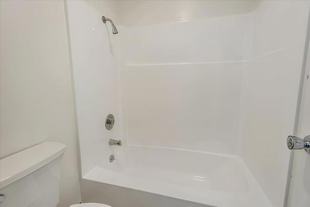 bathroom with washtub / shower combination and toilet