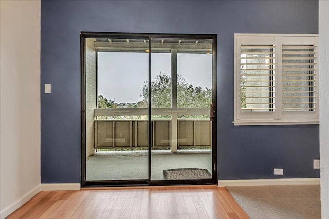 doorway to outside with hardwood / wood-style floors