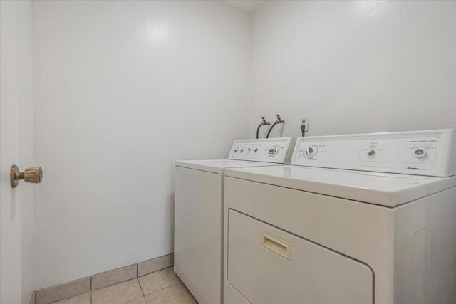 washroom with light tile patterned flooring and independent washer and dryer