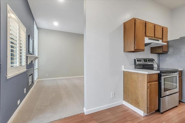 kitchen with stainless steel range with electric cooktop and light wood-type flooring