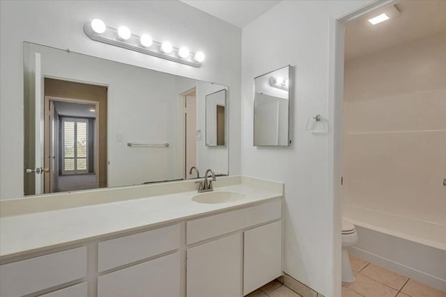 full bathroom with tile patterned floors, toilet, shower / washtub combination, and vanity