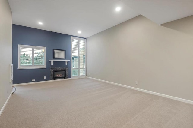 unfurnished living room with light carpet