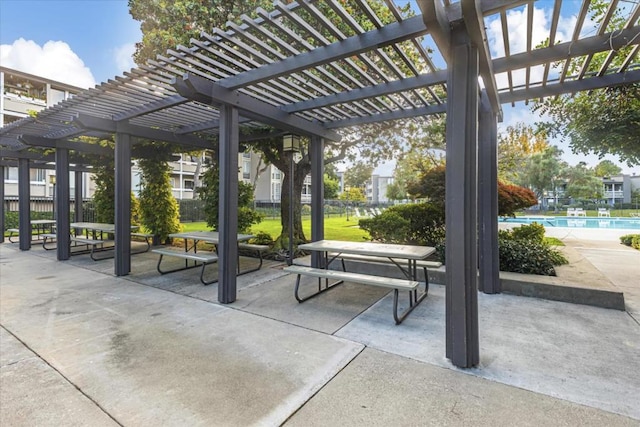 view of property's community featuring a pergola and a patio