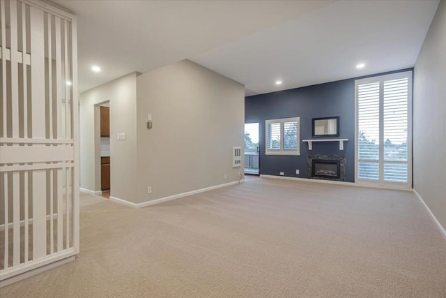 unfurnished living room with light carpet