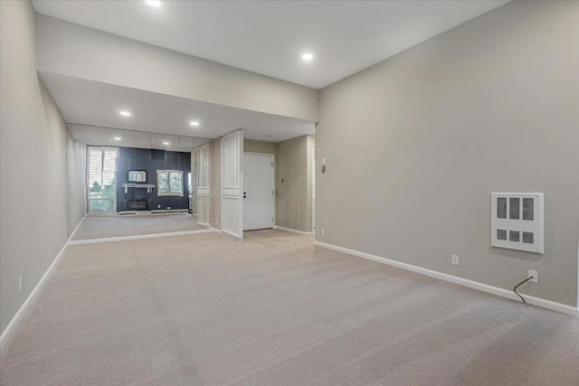 unfurnished living room with light colored carpet