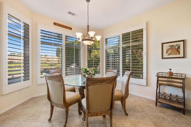 dining space with a wealth of natural light and a notable chandelier