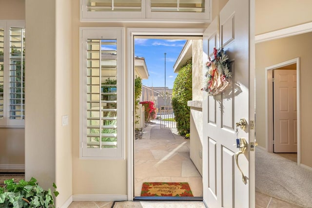 doorway featuring light colored carpet