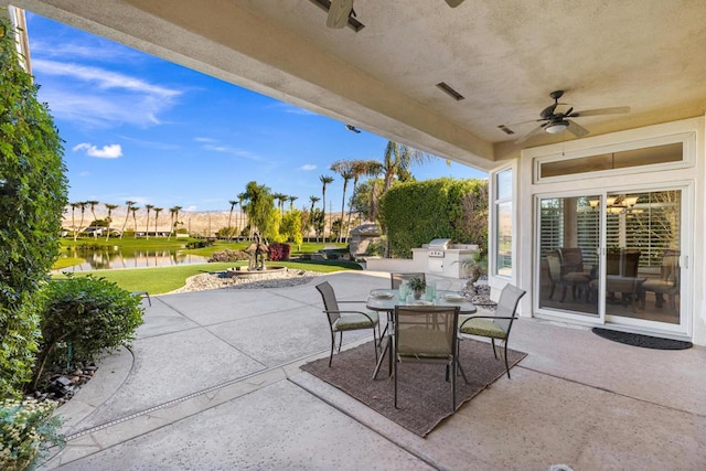 view of patio / terrace featuring ceiling fan and a water view