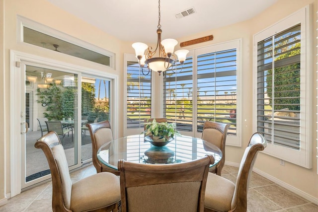 tiled dining area with a chandelier