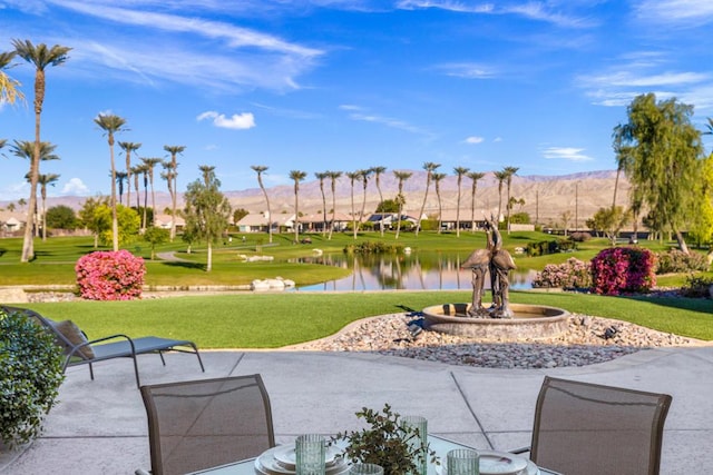 view of home's community with a lawn and a water and mountain view