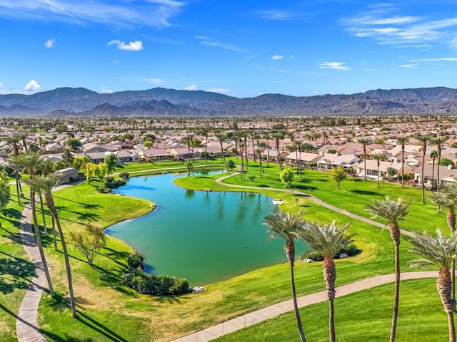 view of community with a lawn and a water and mountain view