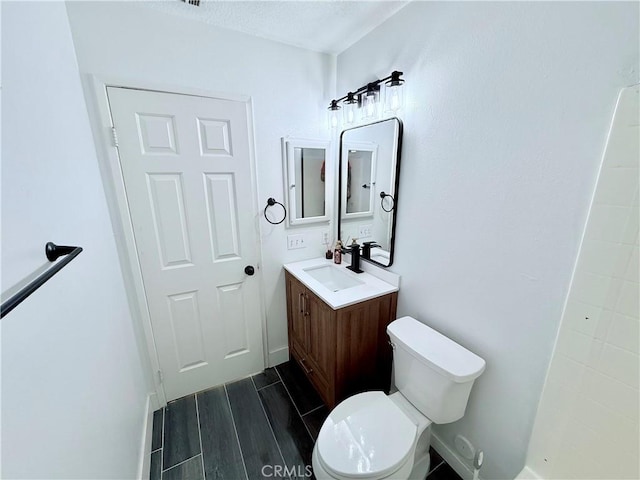 bathroom featuring toilet and vanity