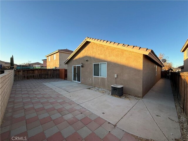 back of house featuring cooling unit and a patio