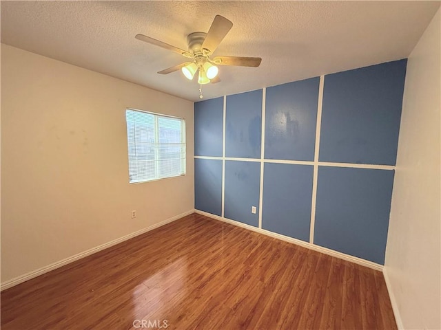 empty room with ceiling fan, a textured ceiling, and hardwood / wood-style flooring