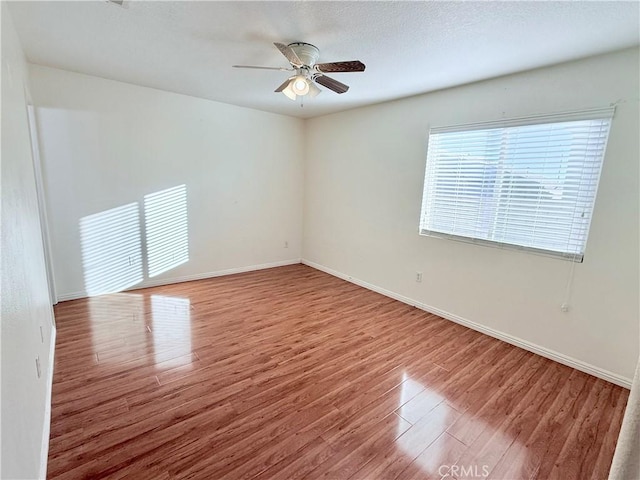 spare room featuring ceiling fan and hardwood / wood-style flooring