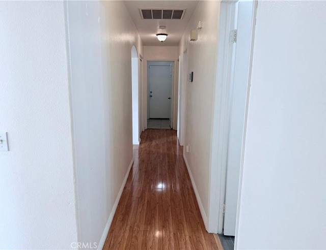 hall with hardwood / wood-style floors