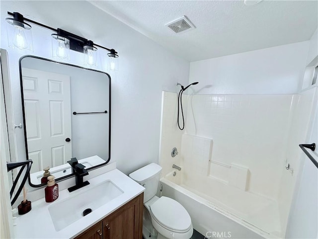 full bathroom featuring toilet, vanity, shower / washtub combination, and a textured ceiling