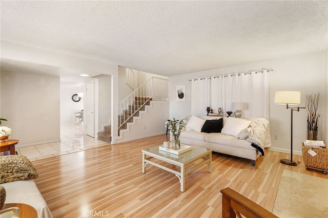 living room featuring hardwood / wood-style floors and a textured ceiling