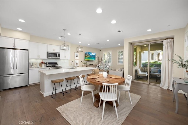 dining space featuring sink and dark hardwood / wood-style floors