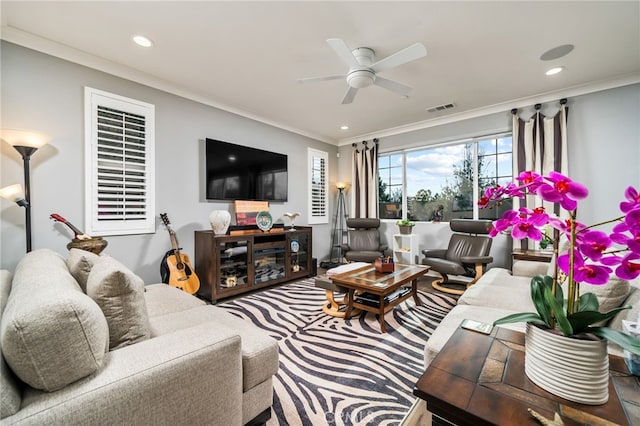 living room with ceiling fan and crown molding