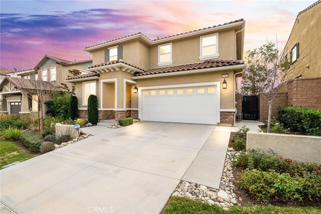 mediterranean / spanish-style home with a garage