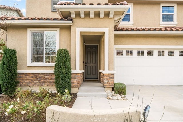 view of exterior entry with a garage