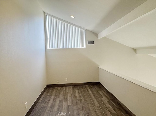 additional living space featuring vaulted ceiling with beams and dark hardwood / wood-style flooring