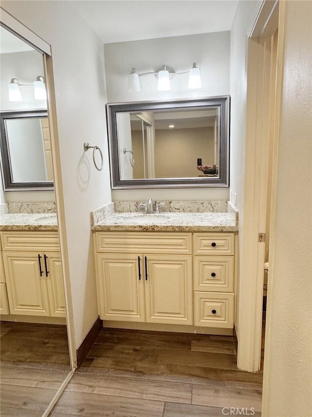 bathroom featuring vanity and hardwood / wood-style floors