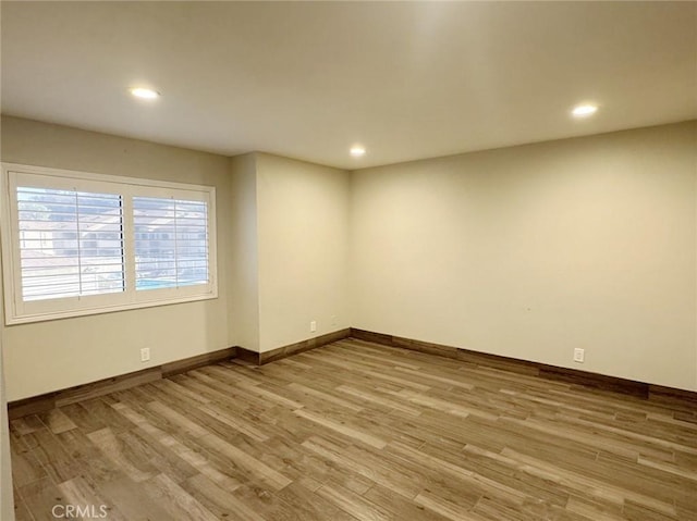 spare room featuring light hardwood / wood-style flooring