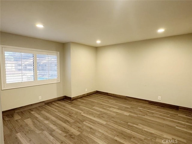 spare room with light hardwood / wood-style floors