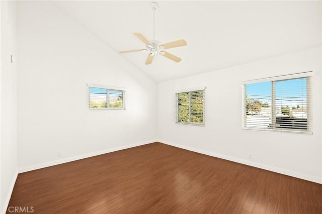 empty room with ceiling fan, high vaulted ceiling, plenty of natural light, and hardwood / wood-style flooring