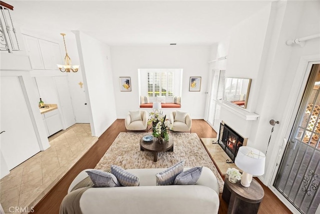 living room featuring a notable chandelier and light hardwood / wood-style flooring