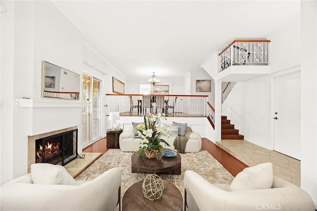 living room with light wood-type flooring and a notable chandelier